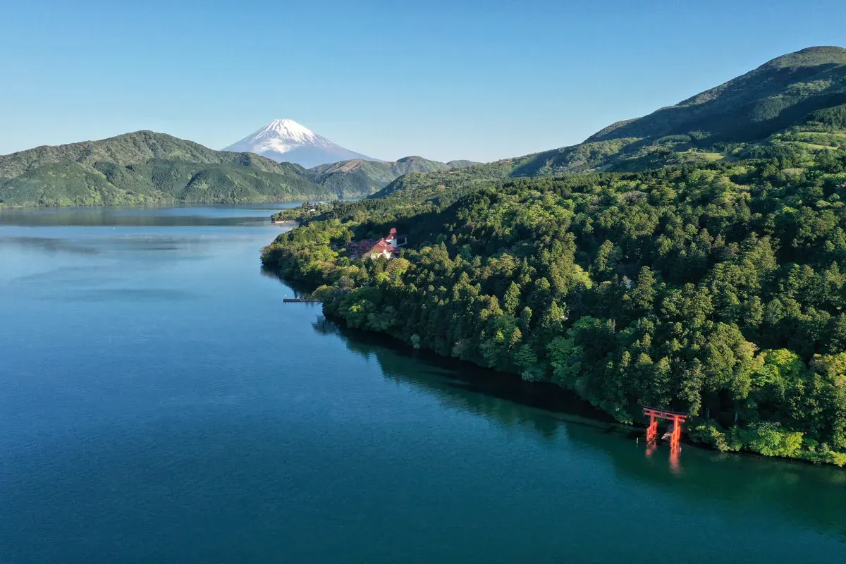 Lake Ashi with Mt Fuji behind and the Hakone Shrine torii on the shore, a day trip from Tokyo