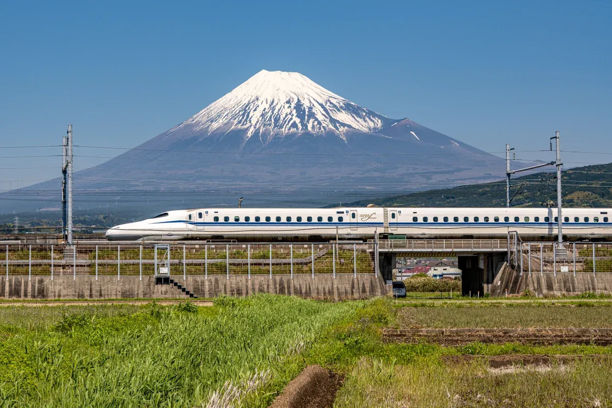 Shinkansen bullet train passing snow-capped Mt Fuji on a bullet train day trip from Tokyo