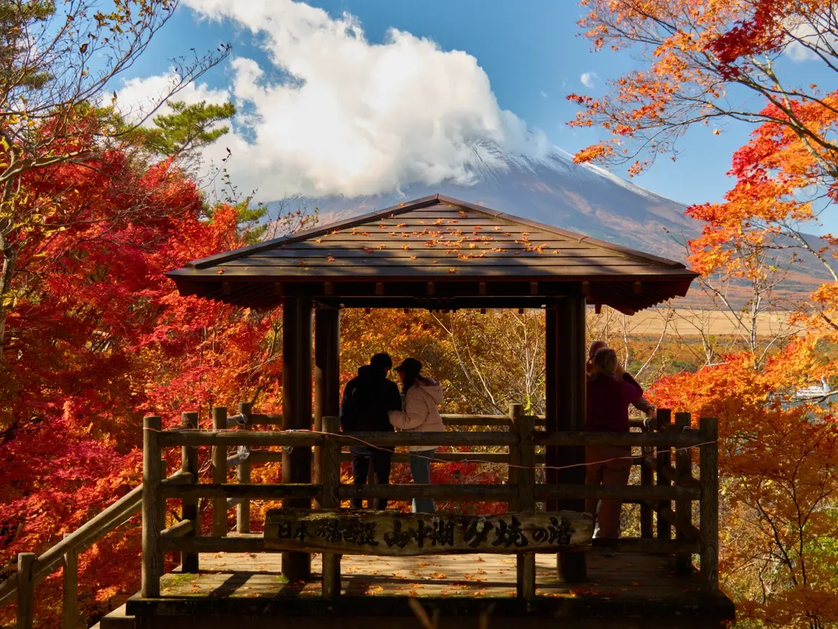 Lookout shelter above Lake Yamanaka with Mt Fuji and autumn maples on a Mt Fuji day trip from Tokyo